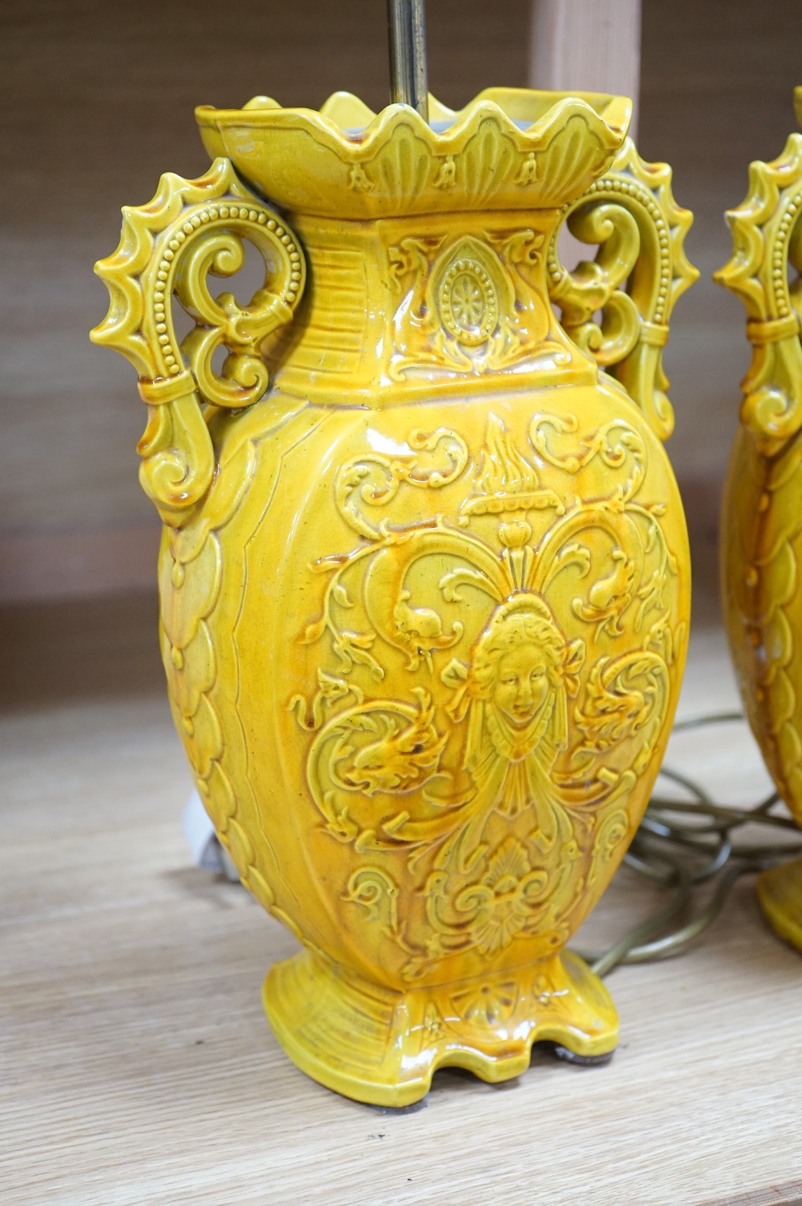 A pair of late 19th century Majolica yellow glazed vases, mounted as table lamps, marked ‘W & Co’ to base, 47cm total